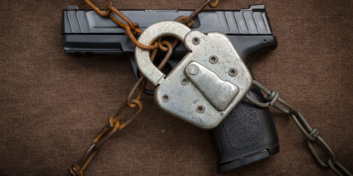 Pistol behind Lock and Chain