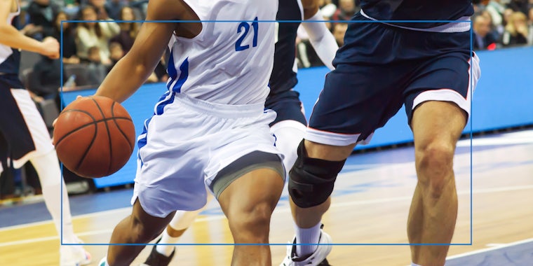 basket ball players playing with blue rectangle in front