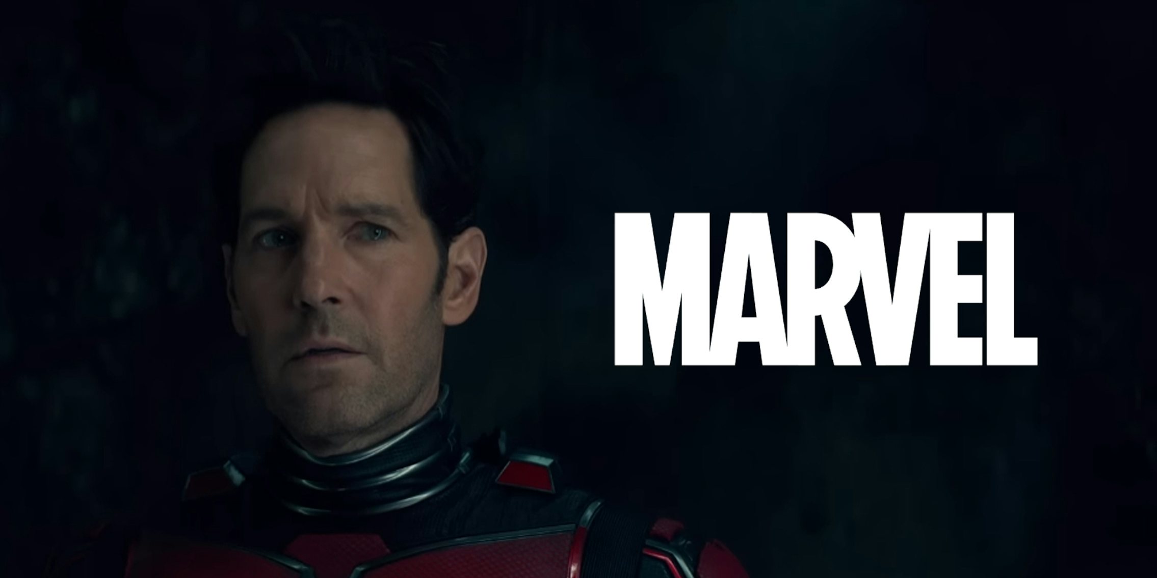 Paul Rudd Ant Man still in Marvel Studios’ Ant-Man and The Wasp: Quantumania with Marvel logo to his right