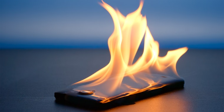 Smartphone lies and burning on a table in the night