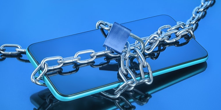 phone with chains and lock on blue background