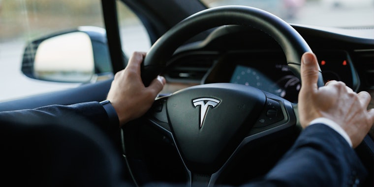 hands on Tesla steering wheel