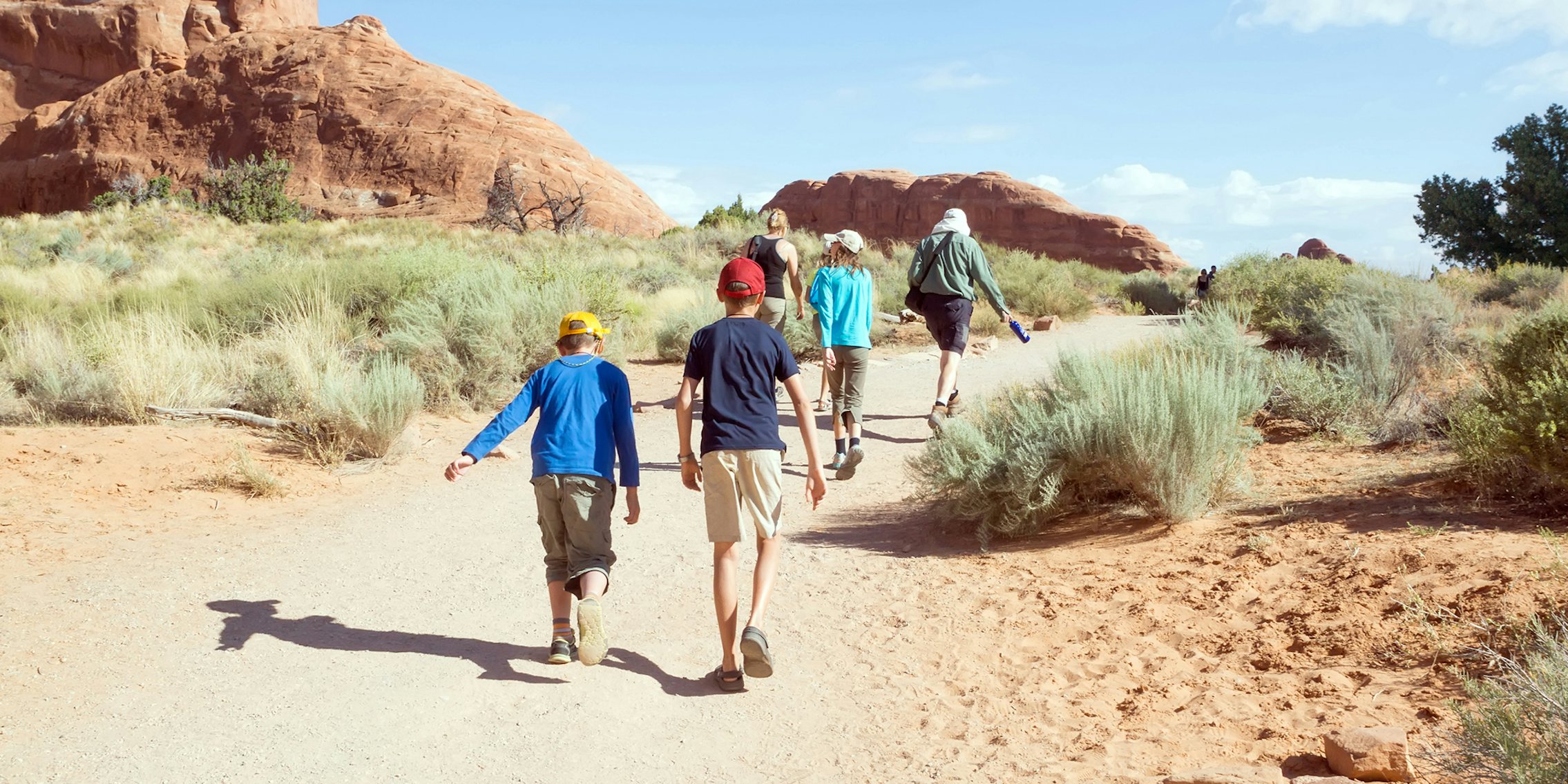 kids and adults hiking in Utah wilderness