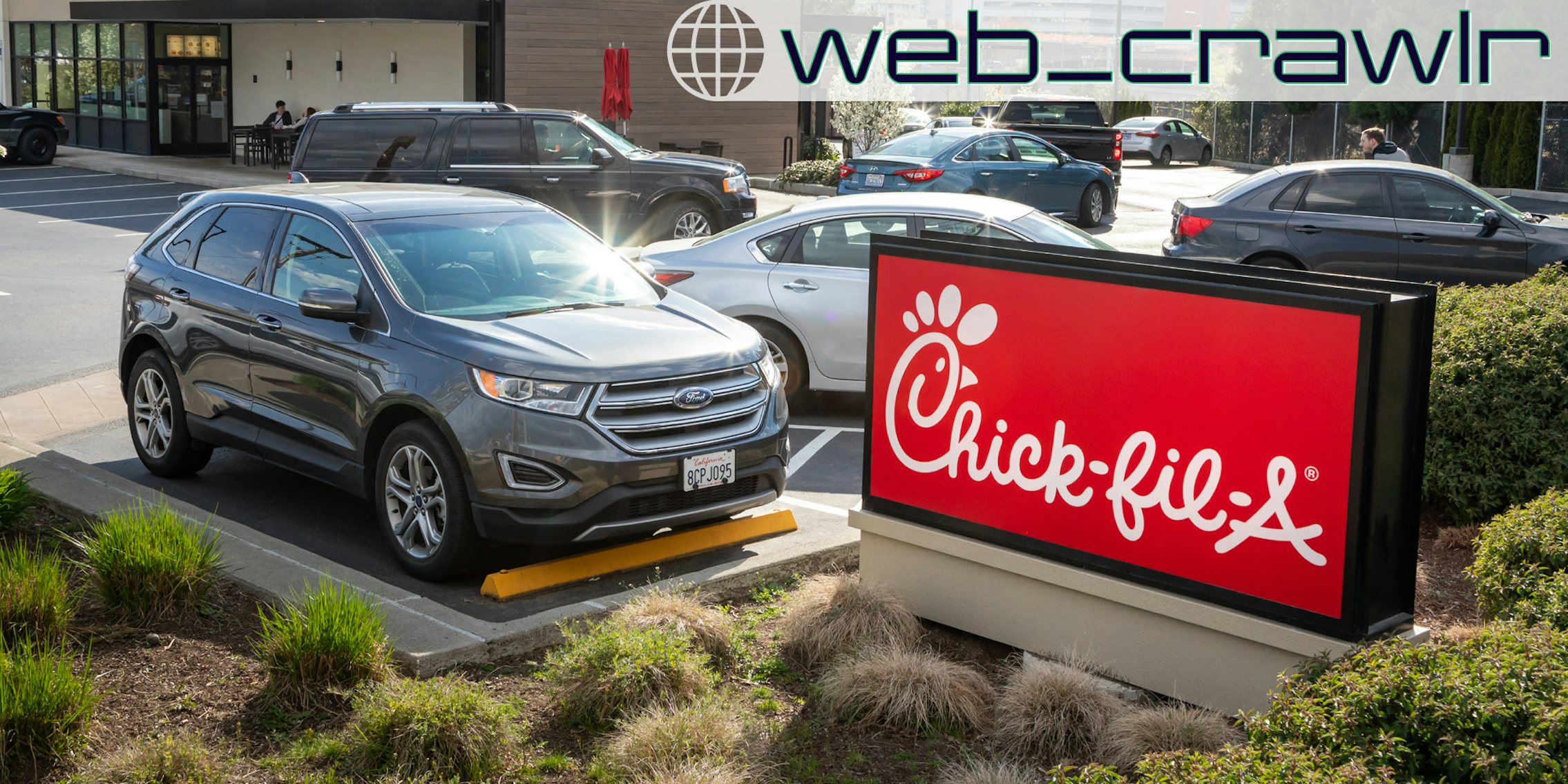 A car parked next to a Chick-fil-A sign. The Daily Dot newsletter web_crawlr logo is in the top right corner.