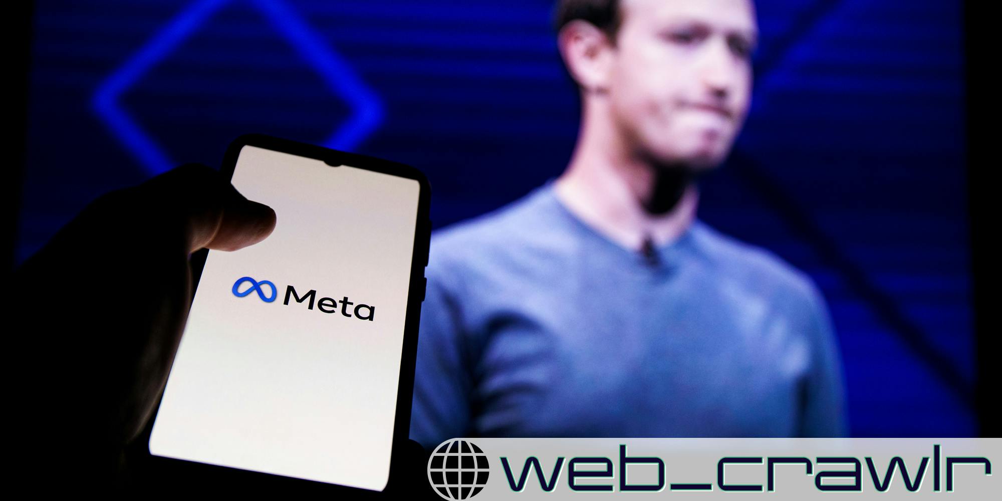 A phone with the Meta logo on it with Mark Zuckerberg in the background. The Daily Dot newsletter web_crawlr logo is in the bottom right corner.