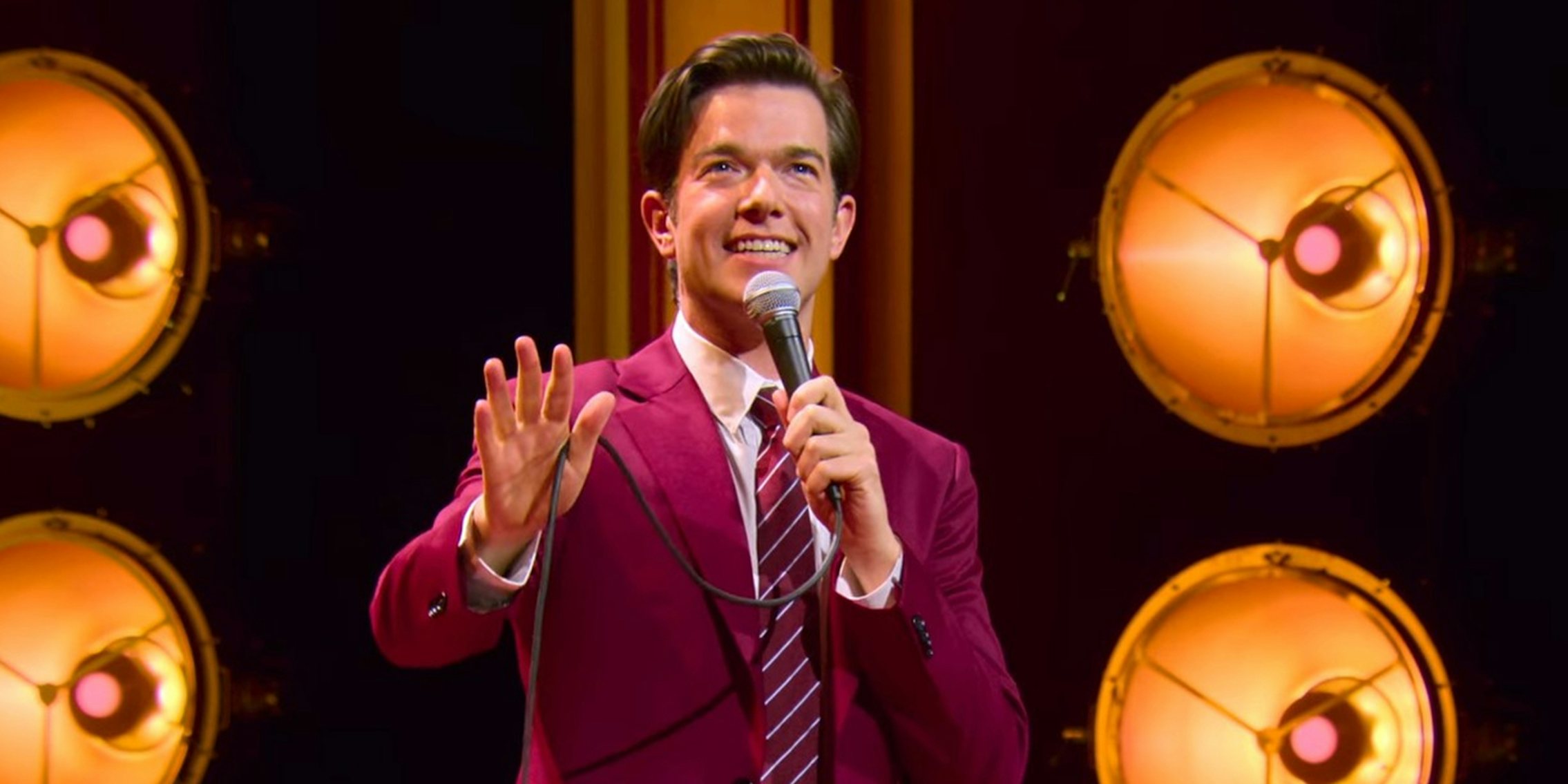 john mulaney in a red suit