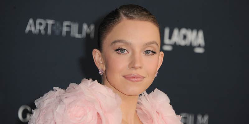 Sydney Sweeney in front of grey background