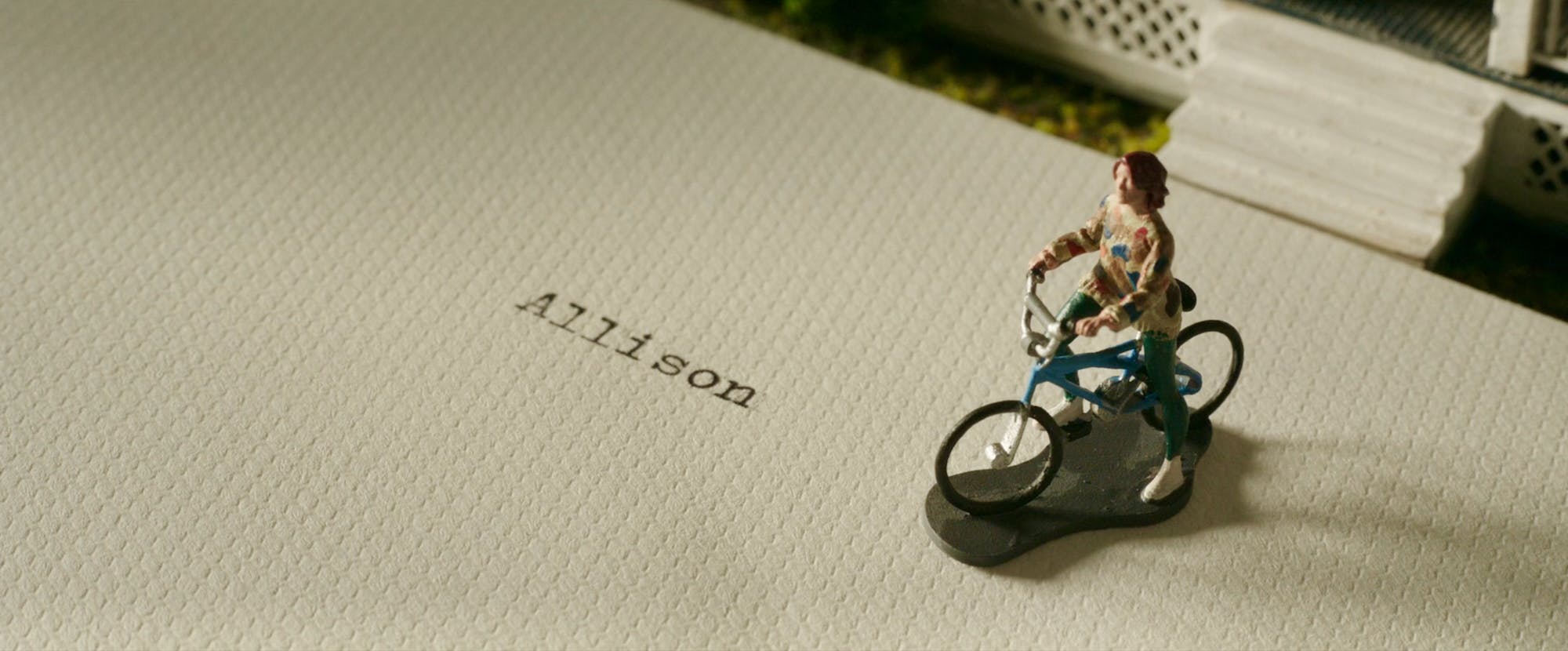 a miniature figure of florence pugh's character in a good person placed on top to a letter addressed to 'allison'