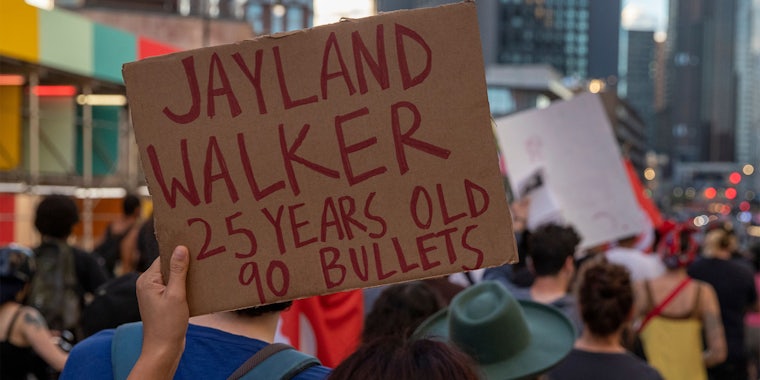 hand holding Jayland Walker 25 years old 90 bullets sign