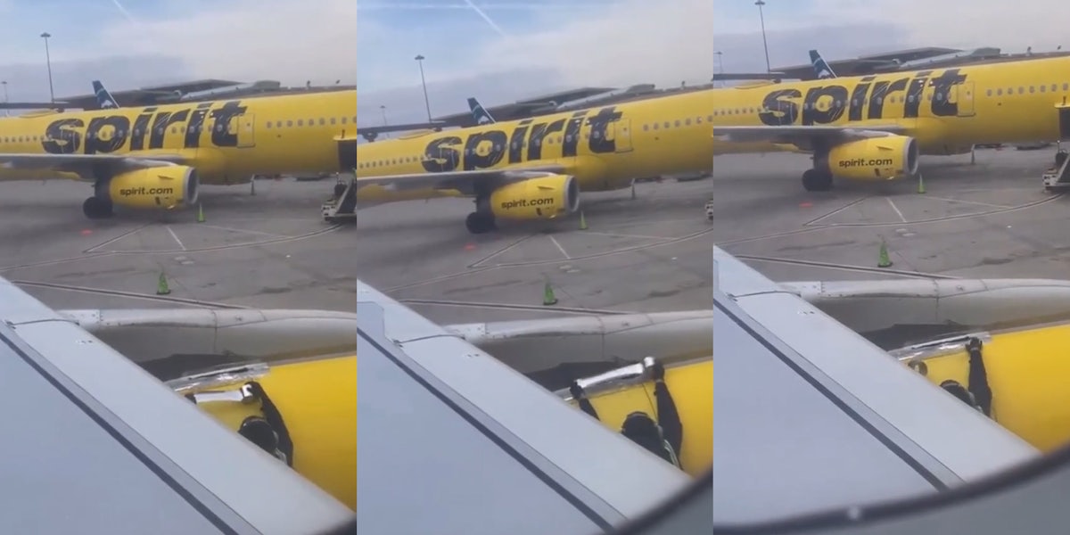 Spirit Airlines worker taping plane in front of another Spirit Airlines plane seen from perspective of passenger in plane (l) Spirit Airlines worker taping plane in front of another Spirit Airlines plane seen from perspective of passenger in plane (c) Spirit Airlines worker taping plane in front of another Spirit Airlines plane seen from perspective of passenger in plane (r)