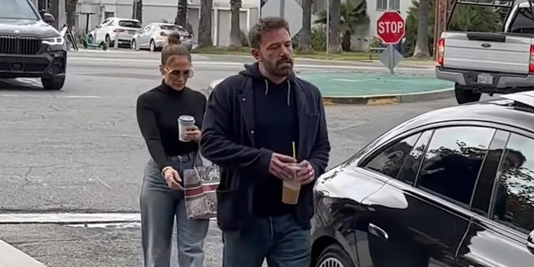 Sad Ben Affleck with Jennifer Lopez outside next to car
