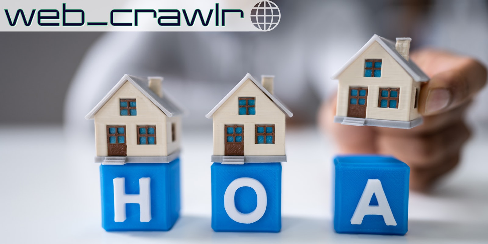 Blocks with the letters HOA on them. Little houses are being placed on the blocks. The Daily Dot newsletter web_crawlr logo is in the top left corner.