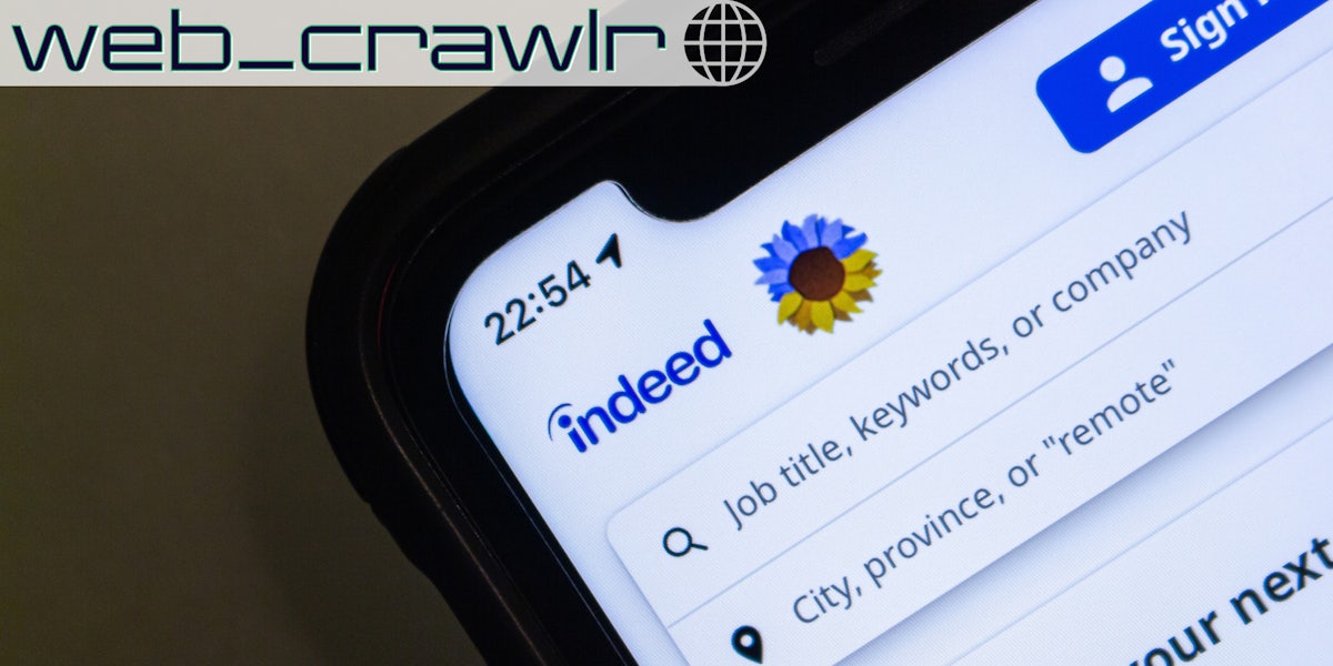 A phone showing the Indeed website on it. The Daily Dot newsletter web_crawlr logo is in the top left corner.