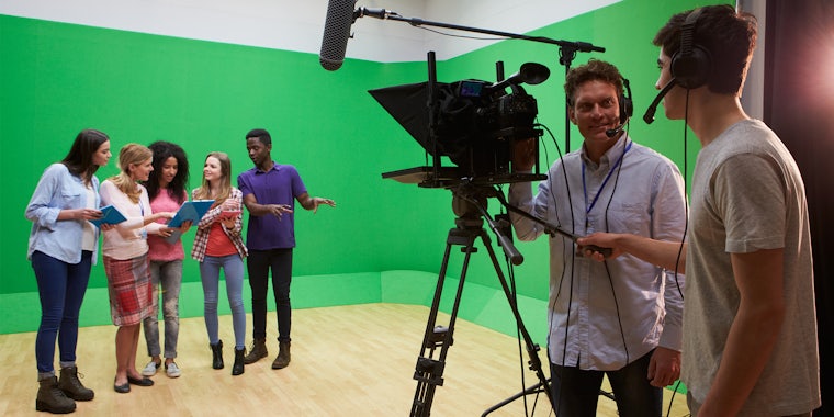 people using green screen and camera