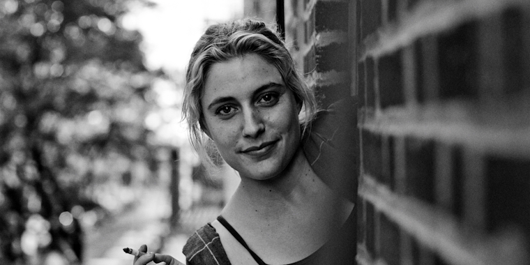 Greta Gerwig leaning out of a patio in NYC in Frances Ha