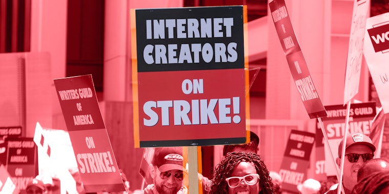 Members of WGA walk with pickets on strike outside the Culver Studio with centered sign reading 'Internet Creators On Strike!' with red overlay Passionfruit Remix