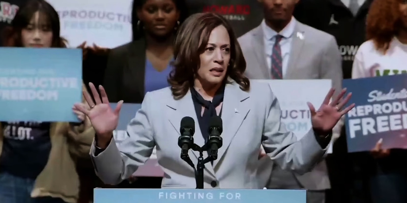 Kamala Harris speaking into microphone in front of crowd