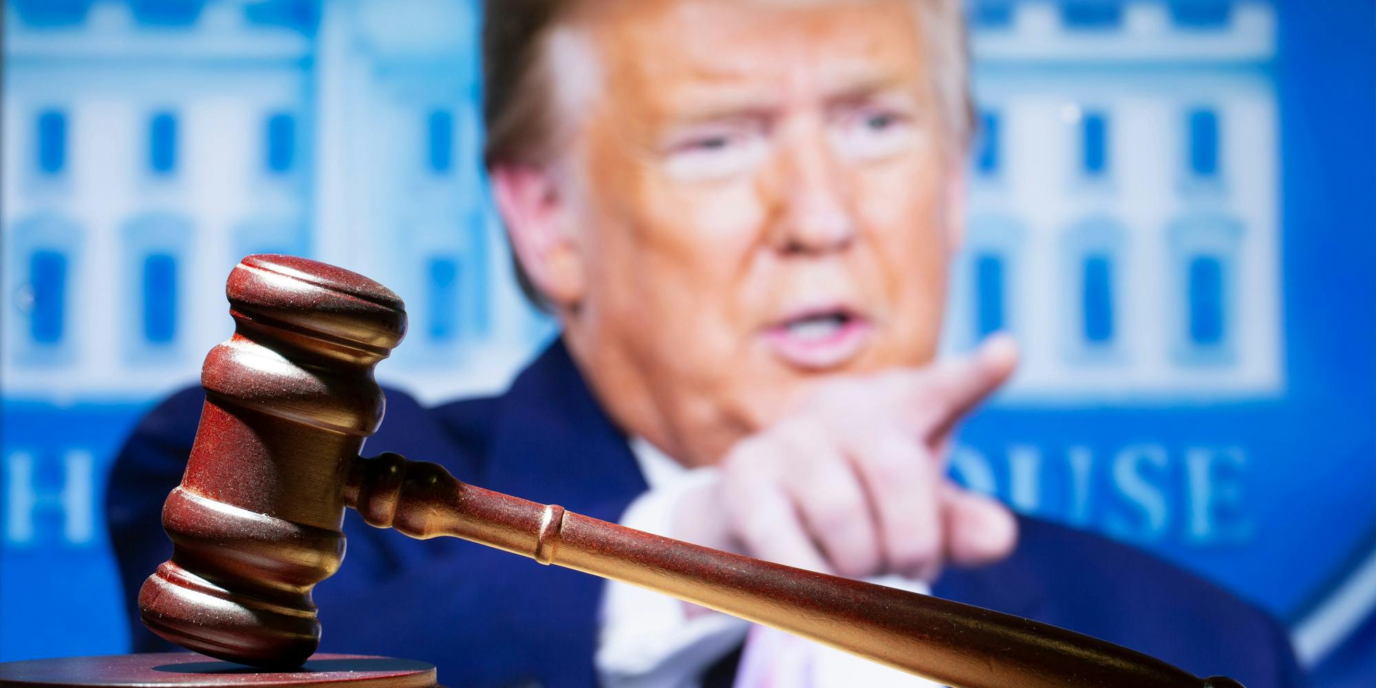 Donald Trump speaking pointing finger behind wooden gavel