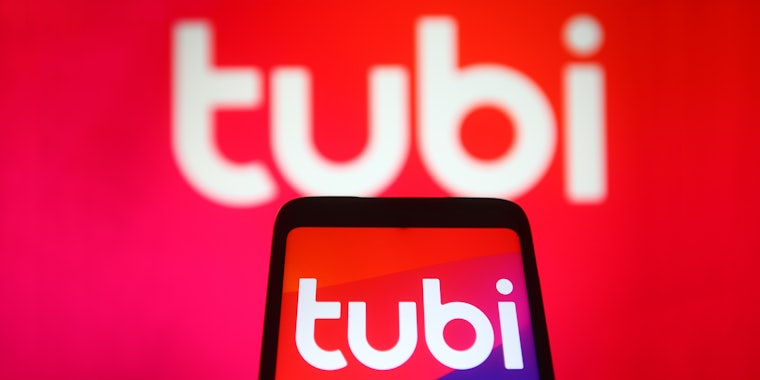 Tubi logo on tv and phone with red and pink background