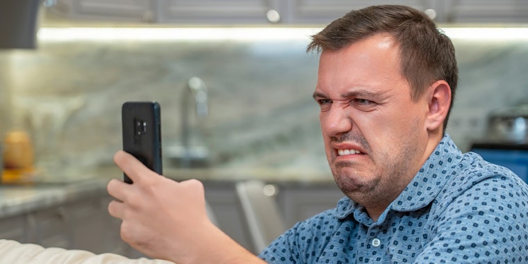 What is cringe? Portrait of man with cringe and looking at phone screen with squeamishness, bad joke or inappropriate content.