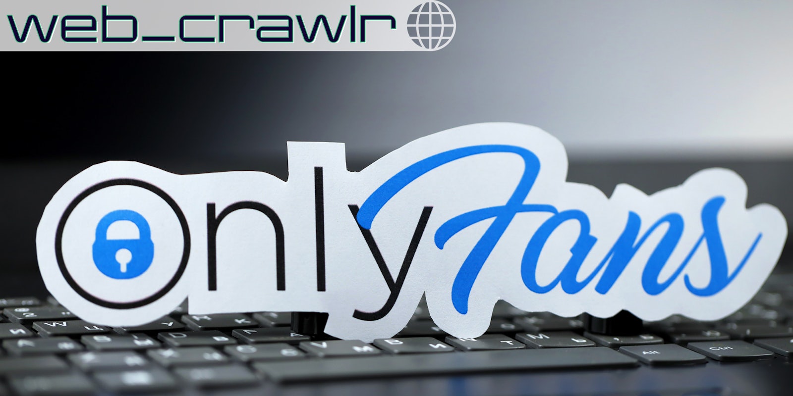 Onlyfans paper logo on black laptop keyboard. The Daily Dot newsletter web_crawlr logo is in the top left corner.