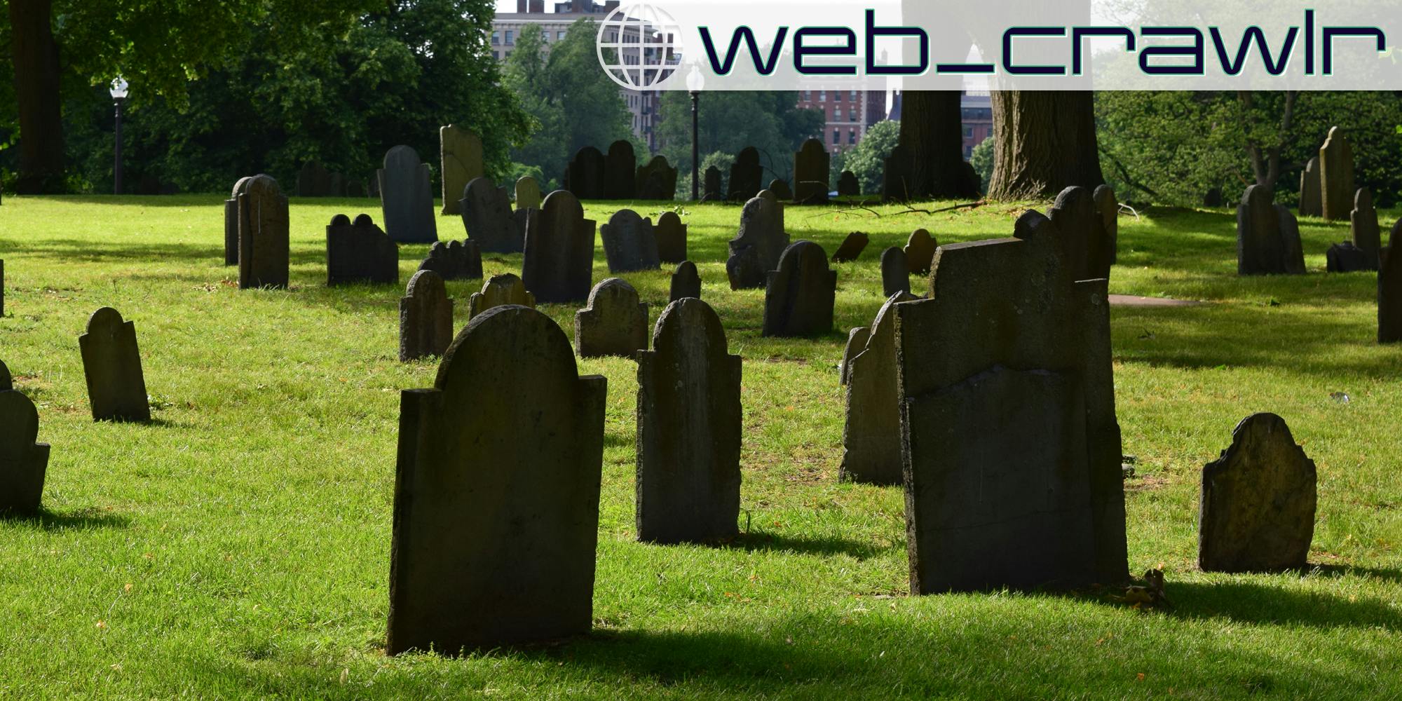 Several grave stones in a graveyard. The Daily Dot newsletter web_crawlr logo is in the top right corner.