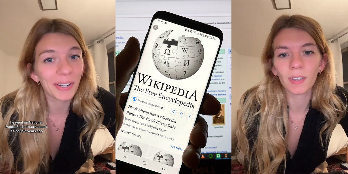 Blond woman wearing black blouse; hand holding up phone with Wikipedia logo shown on screen