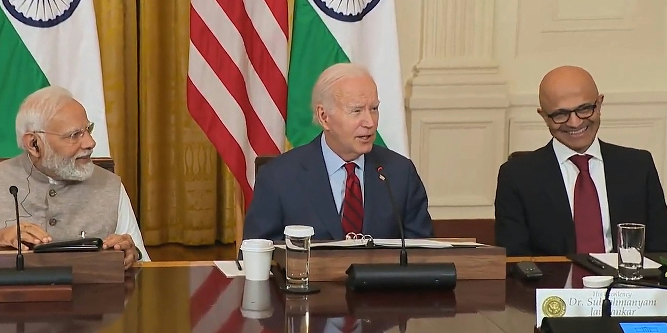 Joe Biden speaking into microphone at the White House