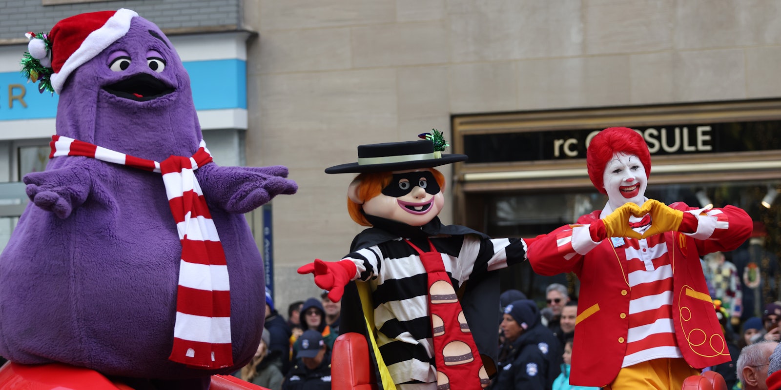 Grimace, Hamburglar, and Ronald McDonald in a big red shoe car at 95th Macy's Annual Thanksgiving Day Parade