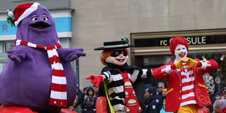 Grimace, Hamburglar, and Ronald McDonald in a big red shoe car at 95th Macy's Annual Thanksgiving Day Parade