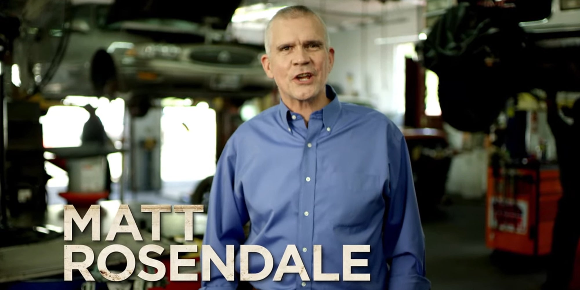 Matt Rosendale speaking in front of blurred mechanic shop background with caption "Matt Rosendale"