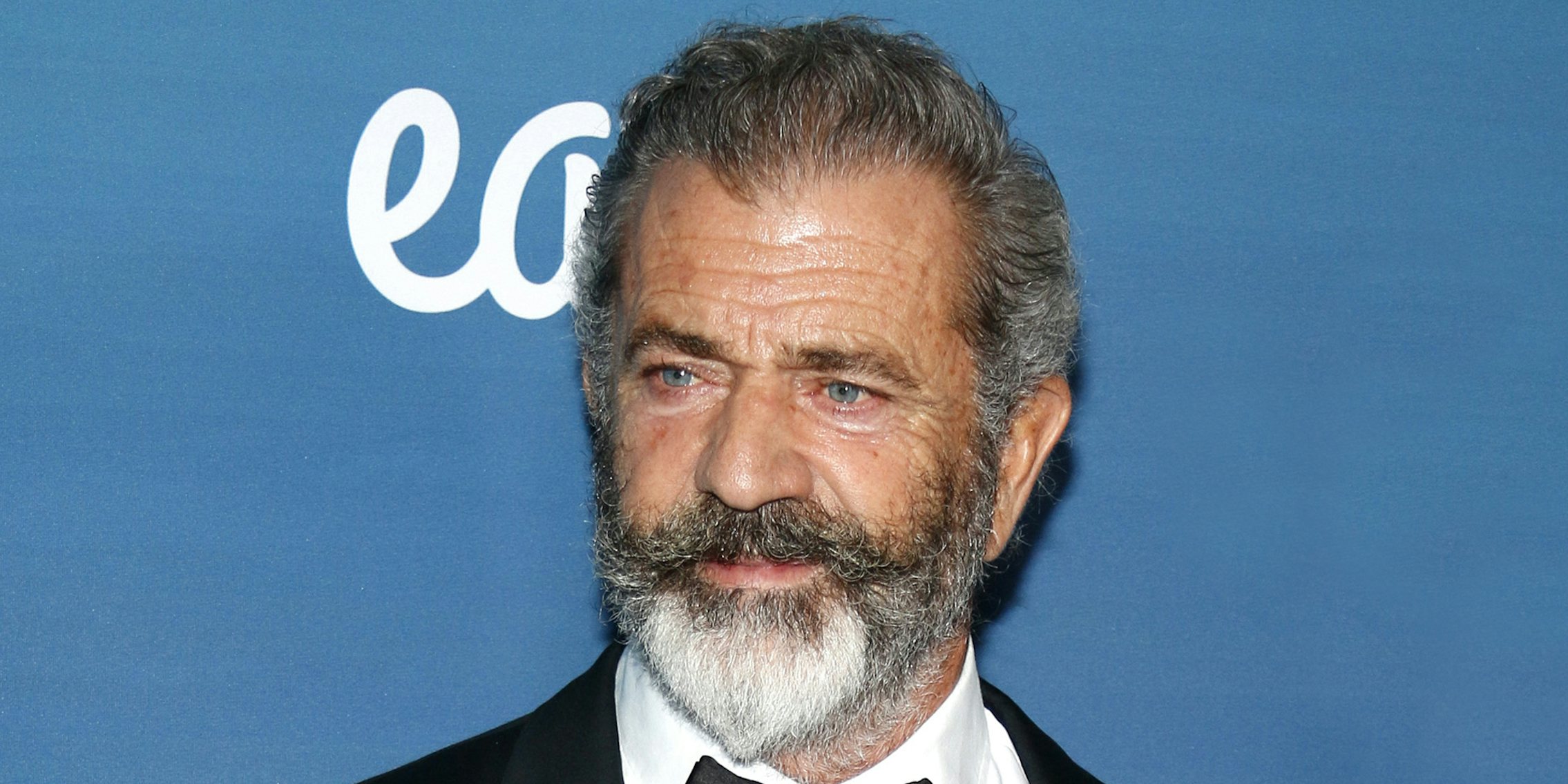 Mel Gibson in front of blue background