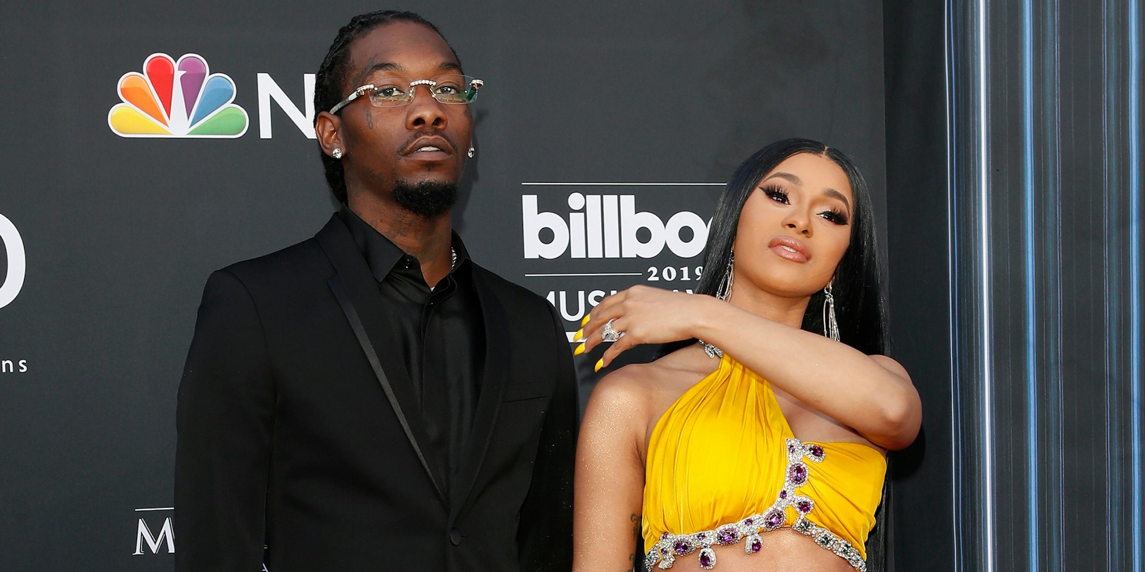 Offset and Cardi B standing in front of grey background at the 2019 Billboard Music Awards at MGM Grand Garden Arena