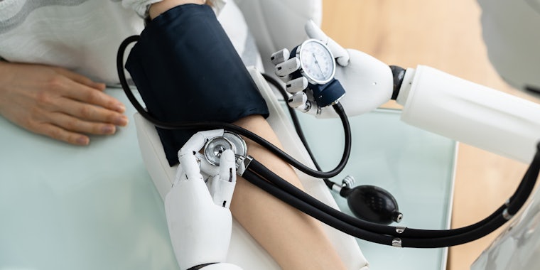 robot doctor taking patient's blood pressure