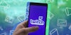 hand holding phone with Twitch on screen in front of green to blue vertical gradient advertisement icons background Passionfruit Remix