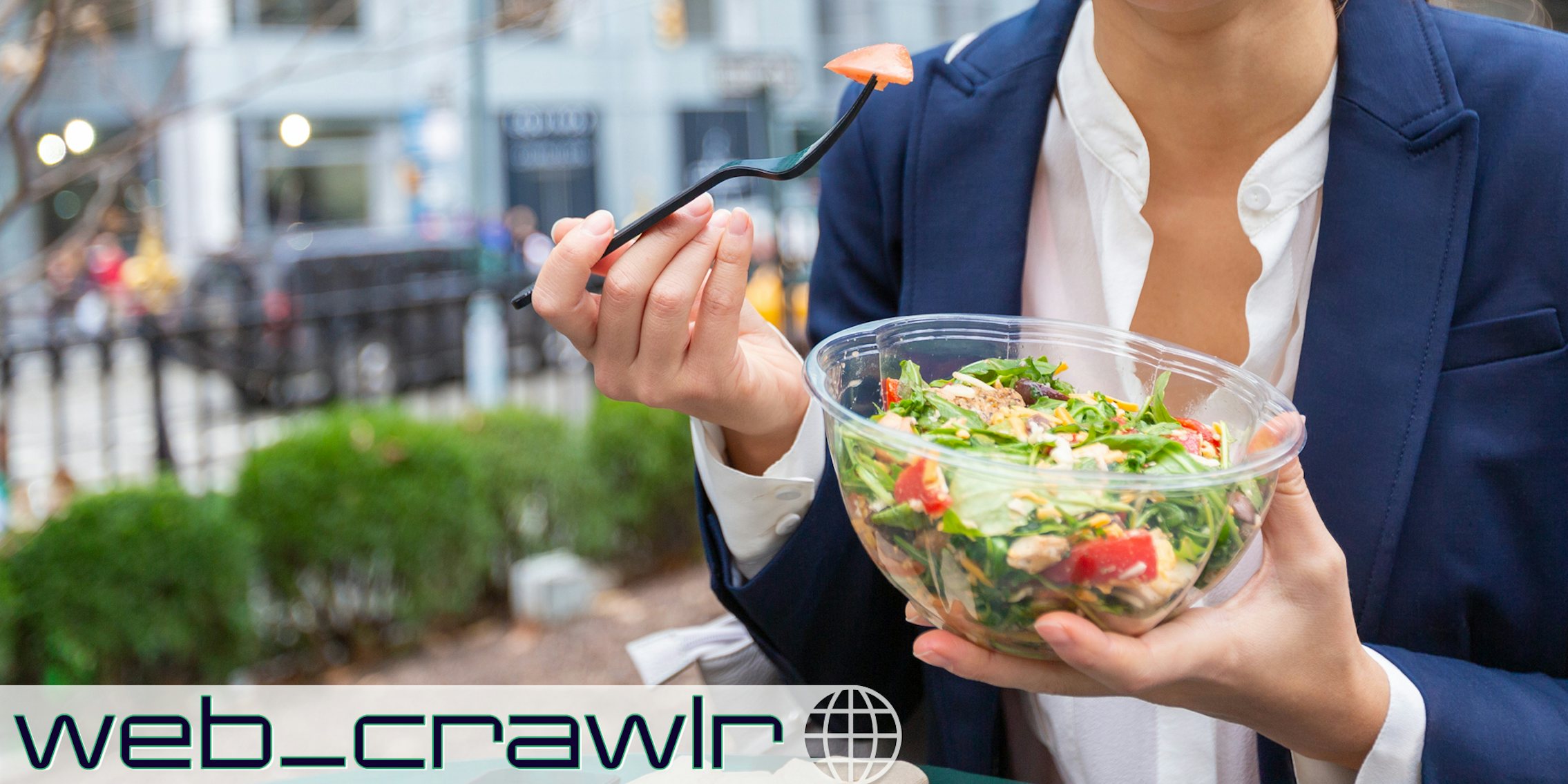 A person holding a bowl of salad. The Daily Dot newsletter web_crawlr logo is in the bottom left corner.