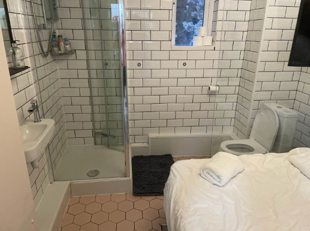 Guest Arrives at Airbnb, Realizes It's a Large Bathroom with a Bed