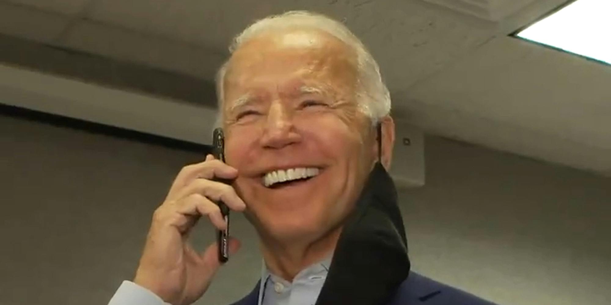 Joe Biden speaking into phone held up to his ear