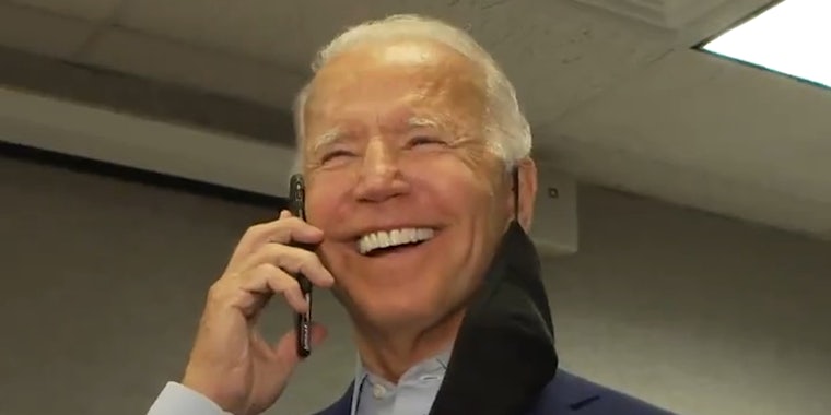 Joe Biden speaking into phone held up to his ear