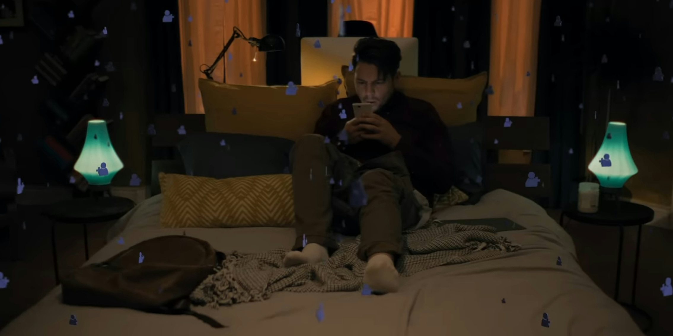 man sitting on bed using phone