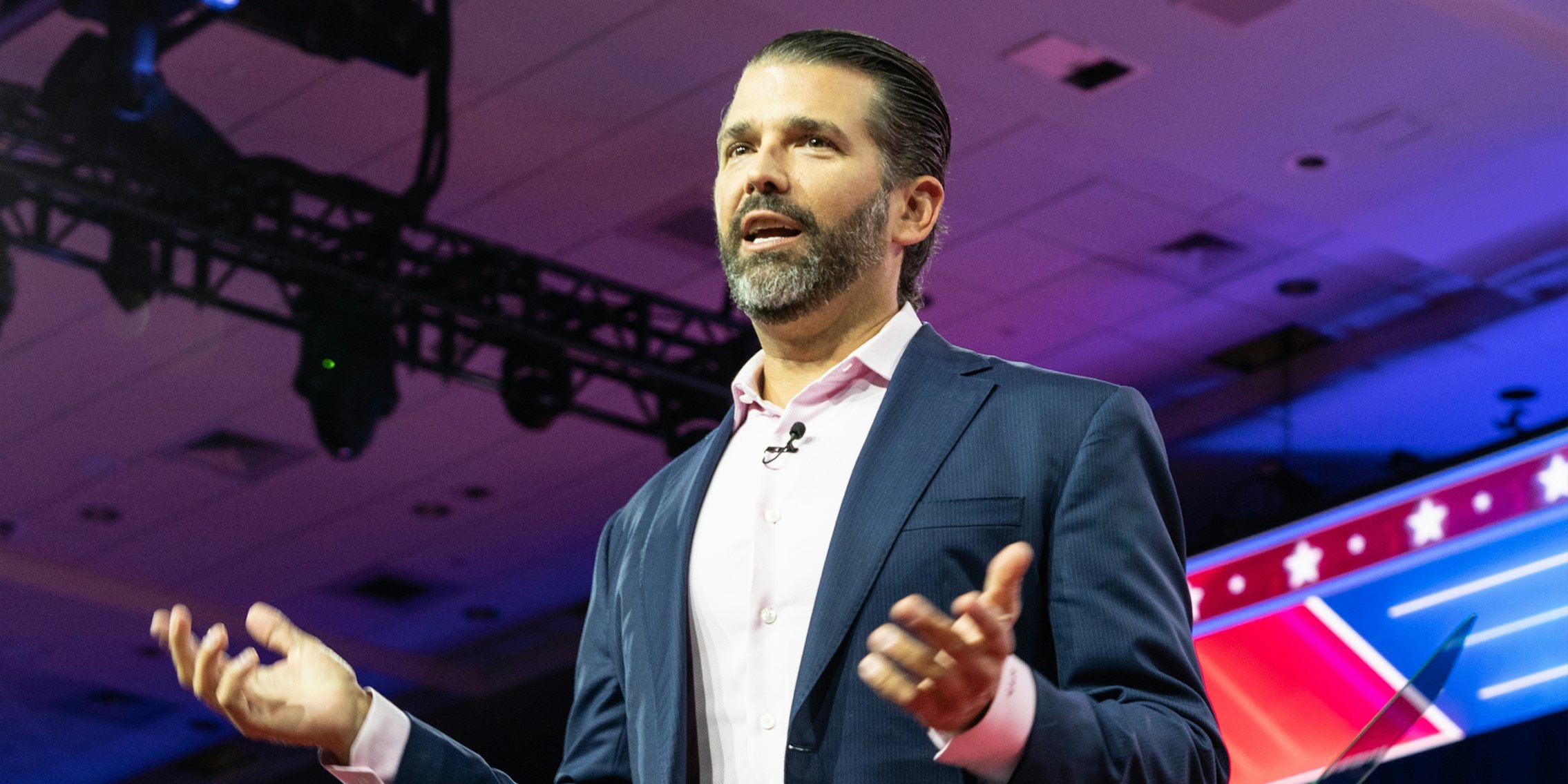 Donald Trump Jr. speaking at CPAC Washington, DC conference at Gaylord National Harbor Resort Convention March 3, 2023 in front of purple red white and blue background