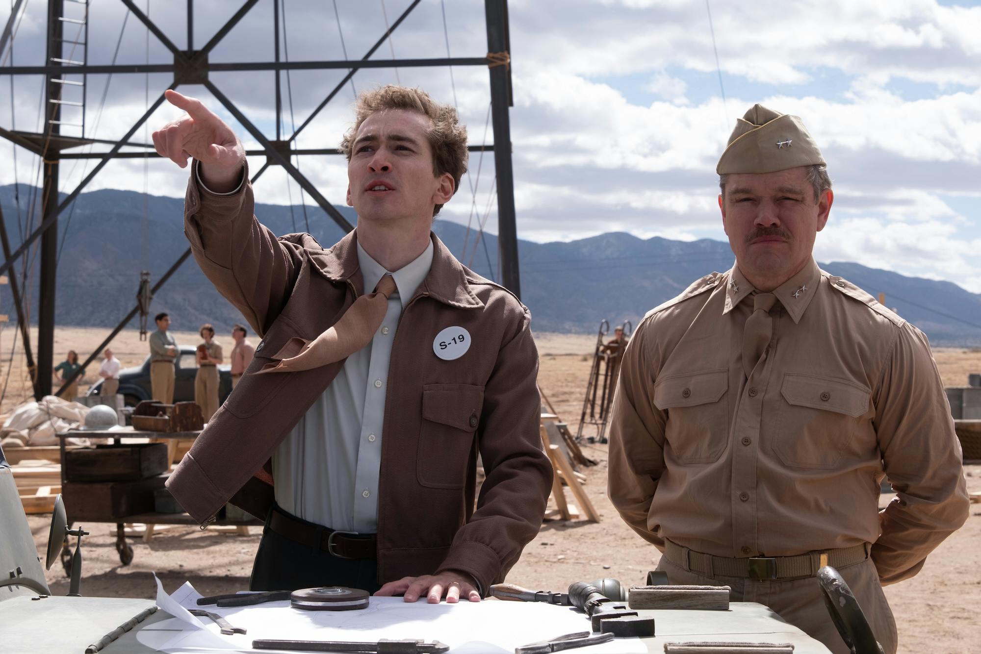 Dylan Arnold as Frank Oppenheimer (left) and Matt Damon as Leslie Groves (right) in Oppenheimer