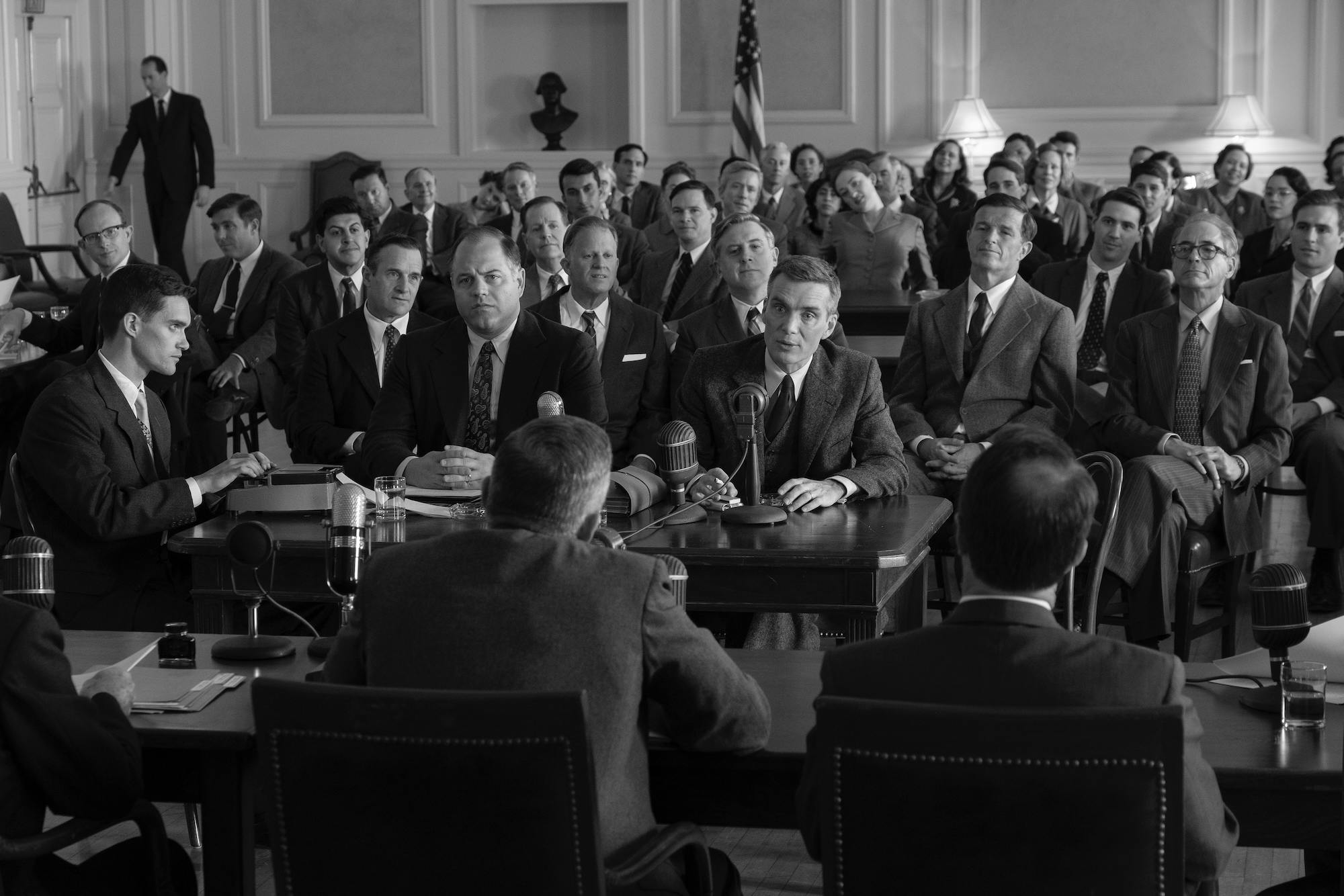 Cillian Murphy as J. Robert Oppenheimer (center) being questioned in Oppenheimer