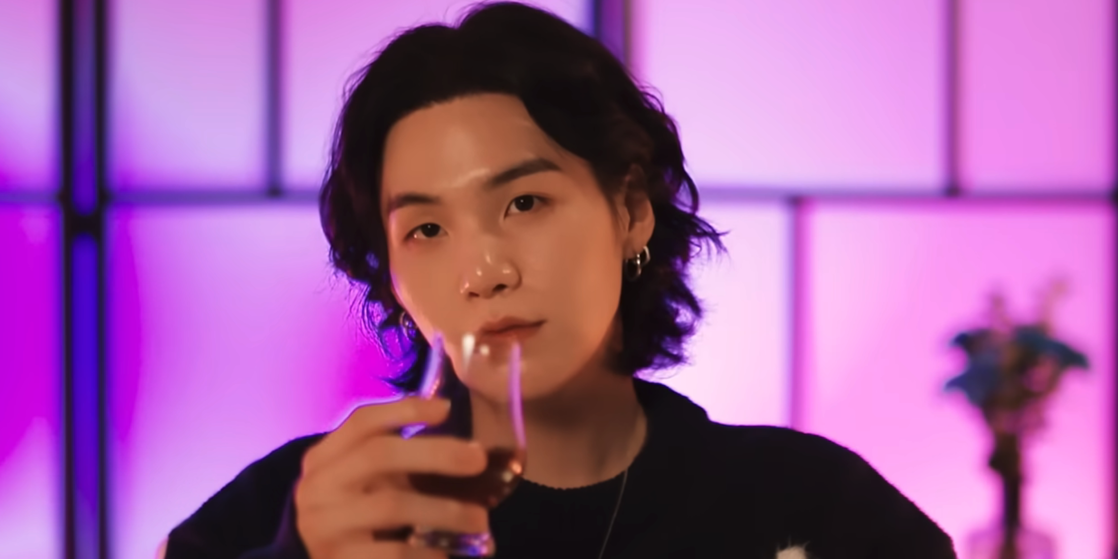 Suga posing with a drink on the webseries suchwita