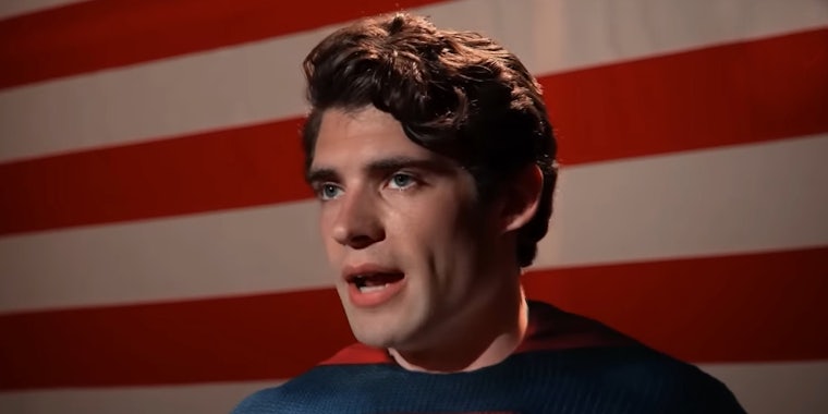 David Corenswet as Superman speaking in front of American flag in Superman Legacy trailer