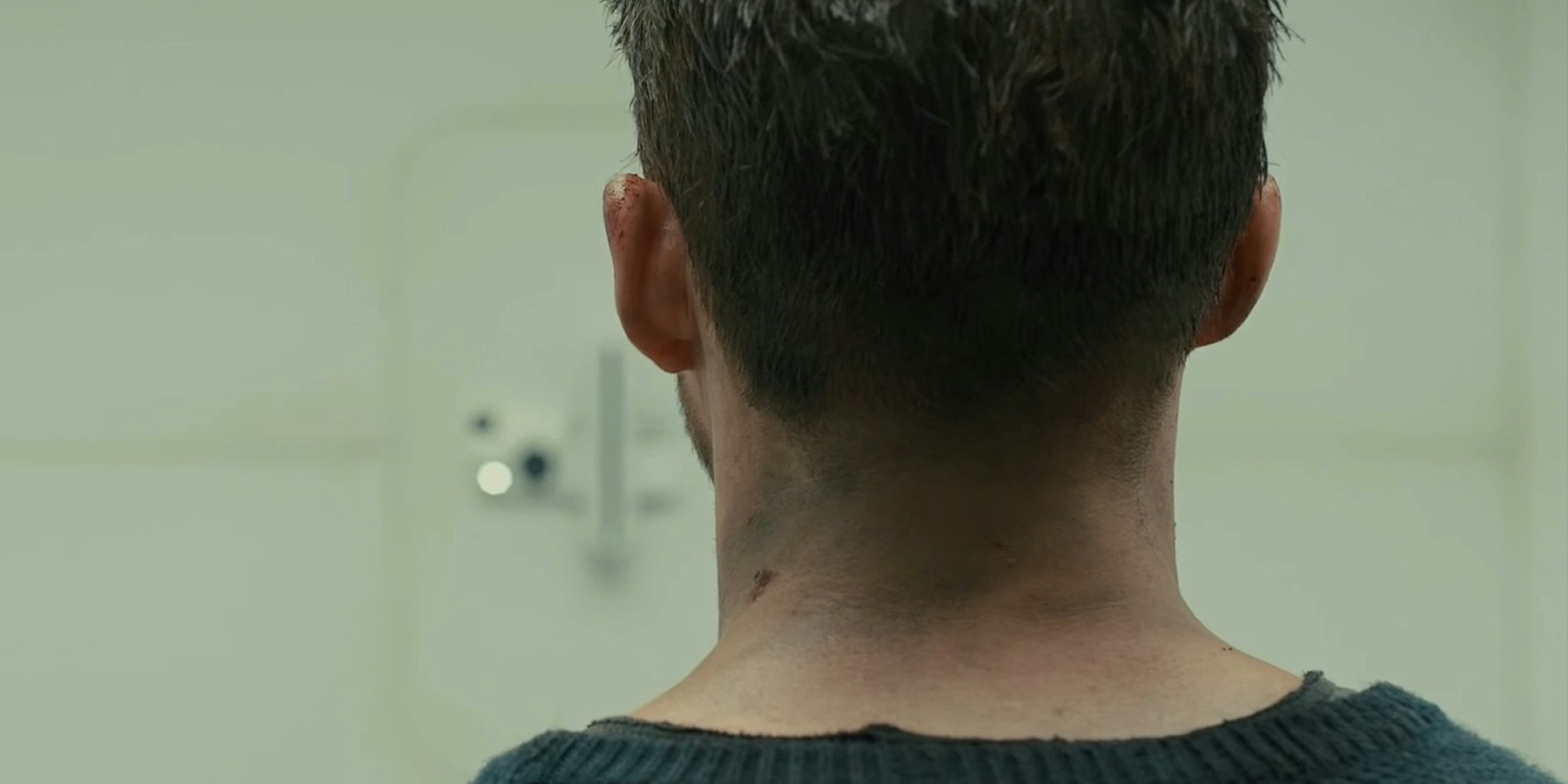 Blade Runner 2049 Cells Interlinked Scene man in front of blurry white wall with electronics