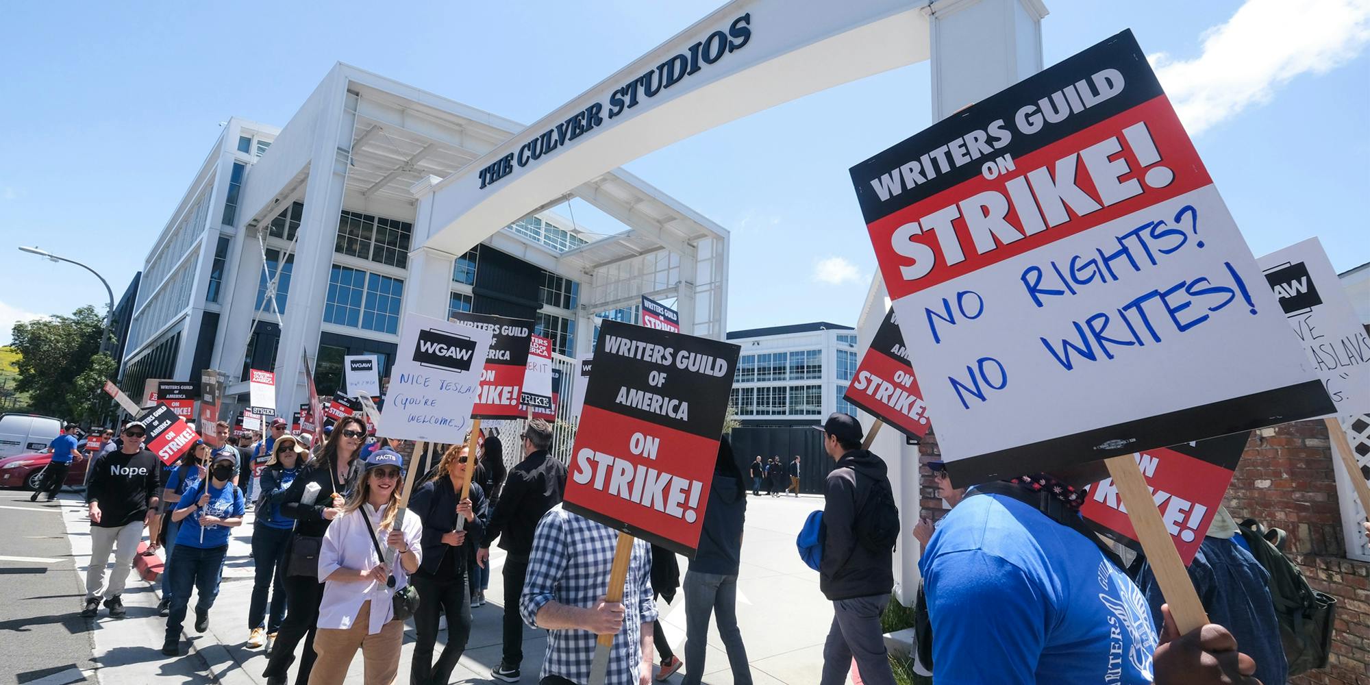 Members of WGA walk with pickets on strike outside the Culver Studio