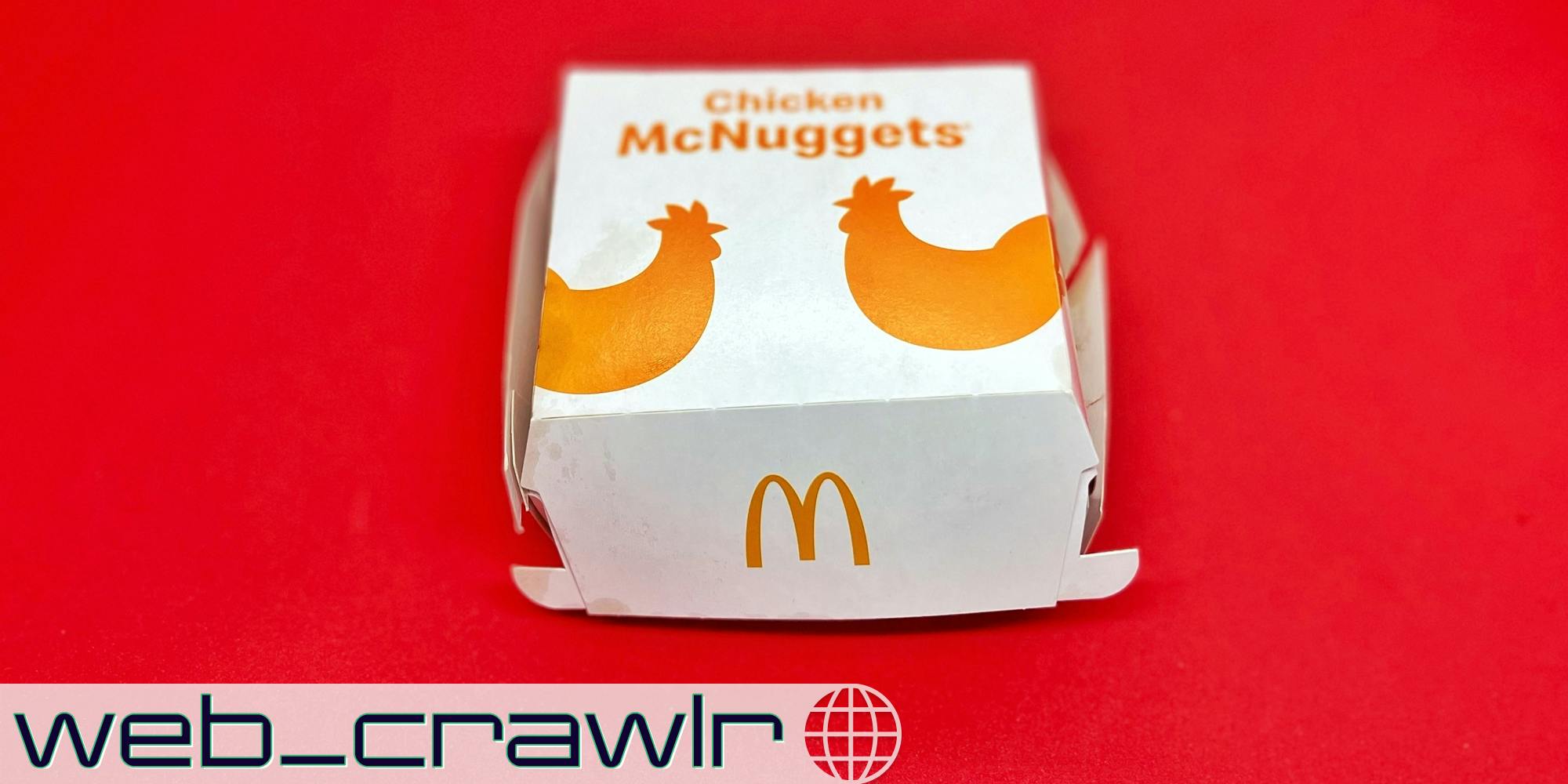 A McNuggets box on a red background. The Daily Dot newsletter web_crawlr logo is in the bottom left corner.