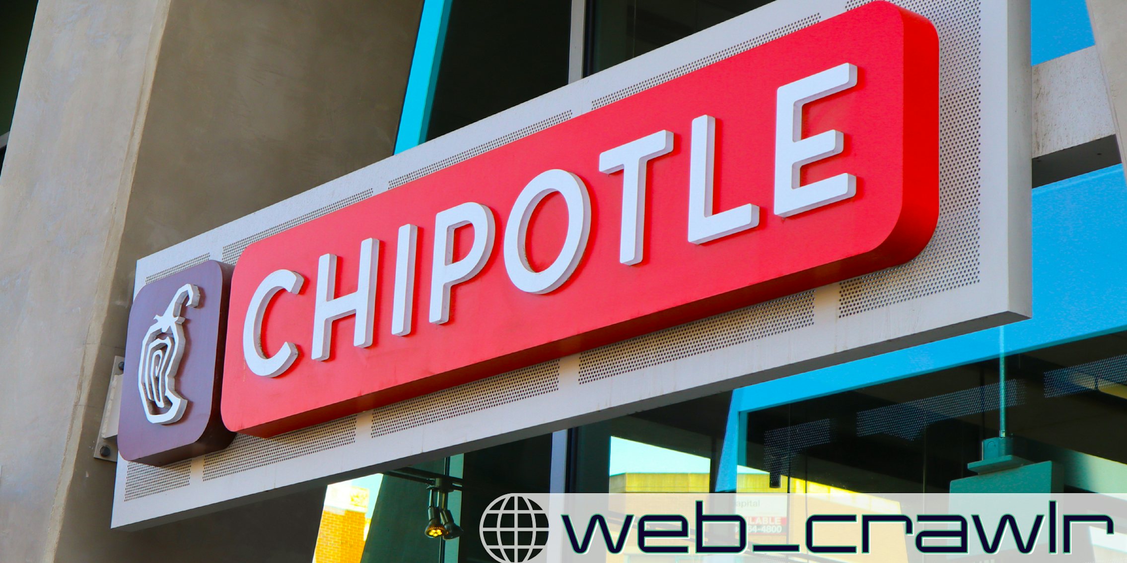 A Chipotle sign on the side of a building. The Daily Dot newsletter web_crawlr logo is in the bottom right corner.