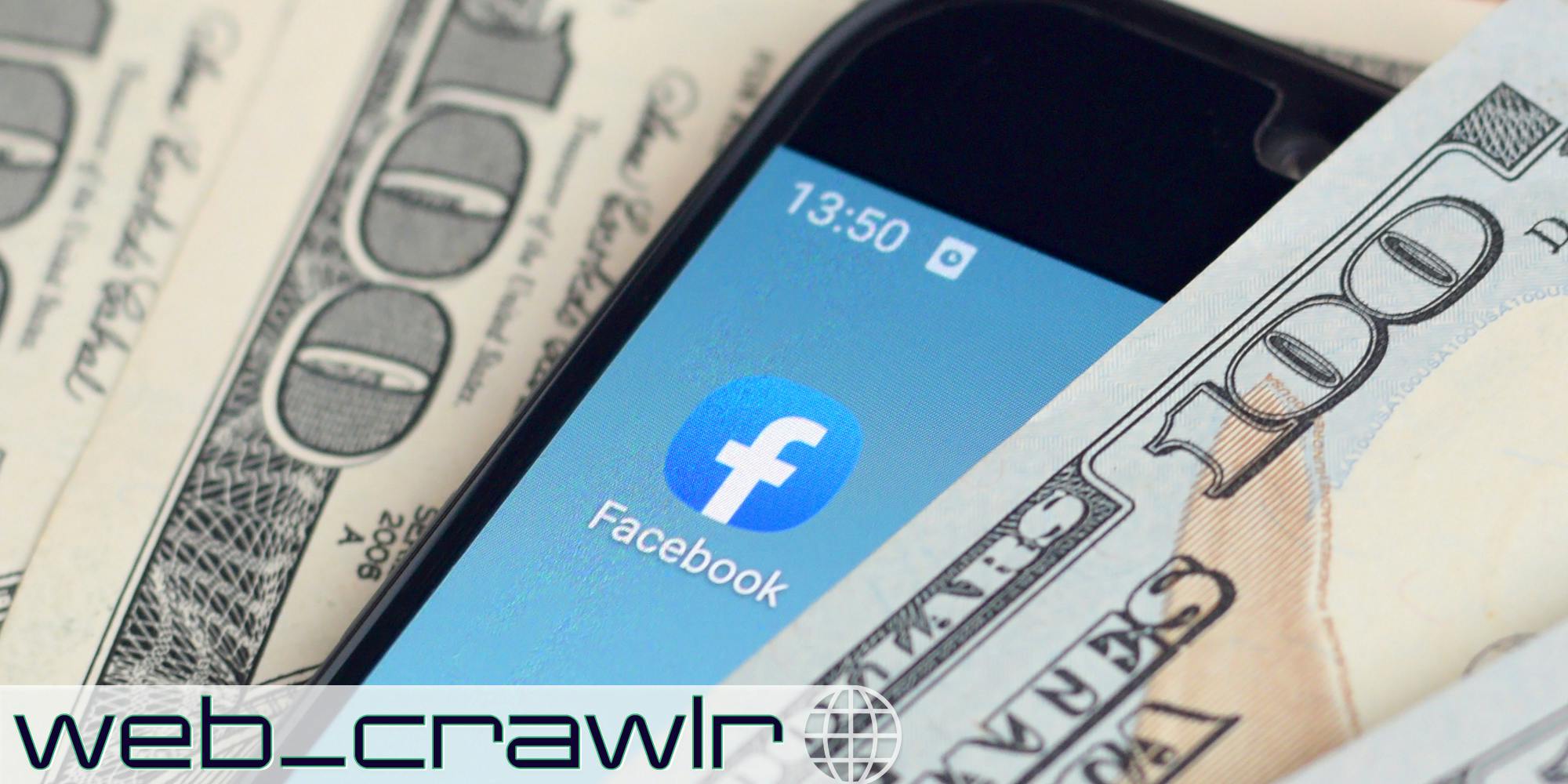 A phone showing the Facebook app next to $100 bills. The Daily Dot newsletter web_crawlr logo is in the bottom left corner.